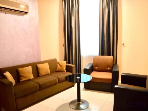 a living room with a couch and a chair at Lotus Furnished Hotel Apartments LLC. Ajman in Ajman 