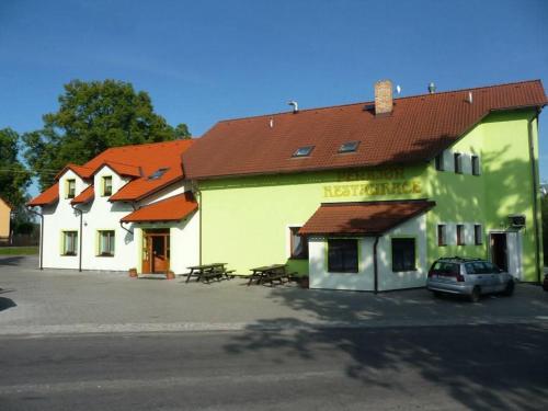 a building with a car parked in front of it at Penzion Zlata studna in Hlinsko