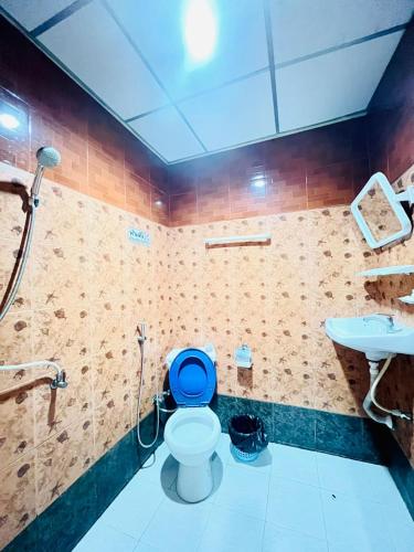 a bathroom with a blue toilet and a sink at Patong Adventure Hostel in Patong Beach