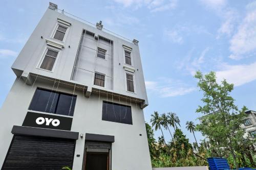 a white building with an ovo sign on it at Hotel O Silver Orchid in Muragācha