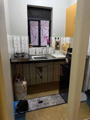 a kitchen with a sink and a window at Fivas Residences in Arua