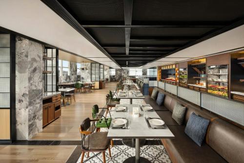 a long dining room with tables and chairs at Four Points by Sheraton Beijing Sanlitun Workers Stadium in Beijing