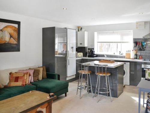 a kitchen and living room with a green couch at Number Two in Bridlington