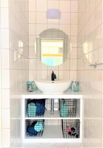 a bathroom with a white sink and a mirror at Ie shima-MONKEY - Vacation STAY 48431v in Ie