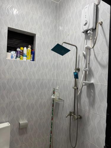 a shower stall in a bathroom with a shower at Fivas Residences in Arua