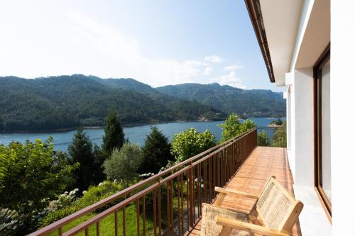 a balcony with a view of a lake at Casas do Picoto - Gerês Nature and Natural River Beach in Terras de Bouro