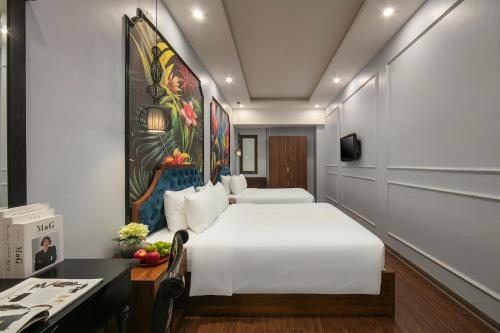 a hotel room with a bed and a desk at Elegance Premium Hotel in Hanoi