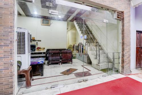a room with a glass window with a stairway at Super Hotel O Mathura Central Railway Junction Formerly Bhagwati Palace in Mathura
