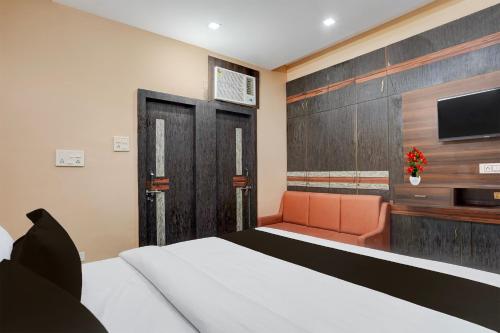 a hotel room with a bed and a tv at Super Collection O Patliputra Sports Complex Formerly Wellfood Inn in Patna