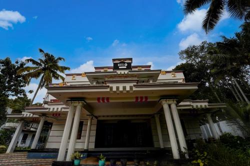 a building with a sign on top of it at Hotel O NIMS Hospital Formerly White Castle in Bālarāmpuram