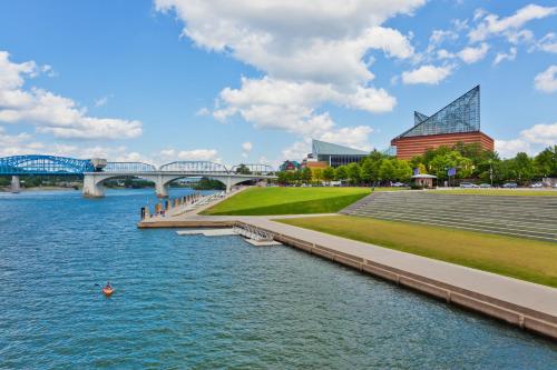 a bridge over a river with buildings and a stadium at Super 8 by Wyndham Chattanooga Lookout Mountain TN in Chattanooga