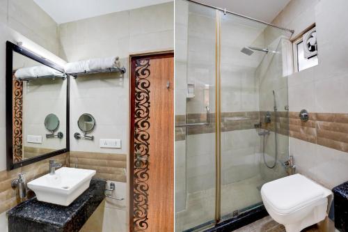 a bathroom with a sink and a shower at Super Townhouse Oak ONGC Crossway Formerly Hotel Gold Stone Comfort in Dehradun