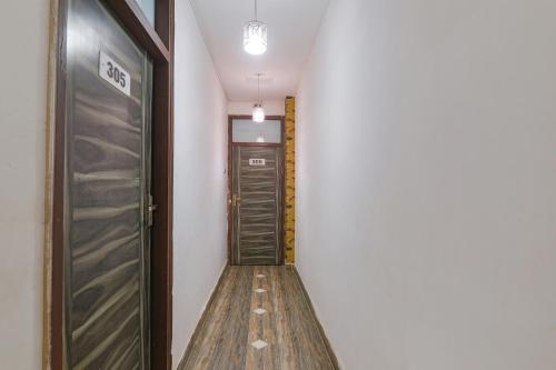 a hallway with two sets of doors in a room at FabHotel Gold Galaxy in Kānpur