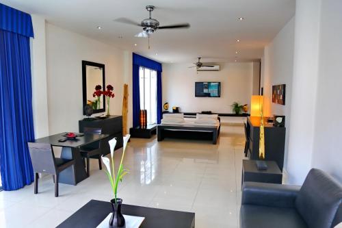 a living room with a couch and a table at East Suites in Pattaya South