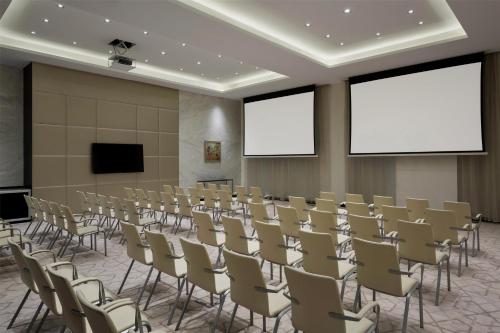 an empty room with rows of chairs and screens at Hyatt Place Riyadh Sulaimania in Riyadh