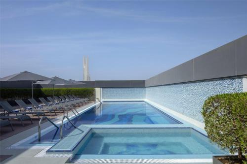 a swimming pool on the roof of a building at Hyatt Place Riyadh Sulaimania in Riyadh