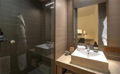 a bathroom with a sink and a shower at FirstName Toulouse, part of JdV by Hyatt in Toulouse
