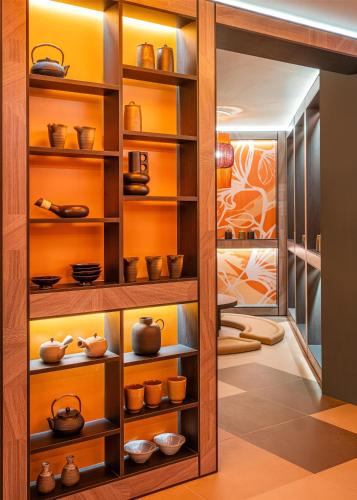 a room with various pots and bowls on shelves at FirstName Toulouse, part of JdV by Hyatt in Toulouse