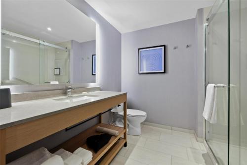 a bathroom with a sink and a toilet and a shower at Hyatt Place Rapid City/Downtown in Rapid City