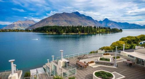 a view of a lake with mountains in the background at Oaks Queenstown Club Suites in Queenstown
