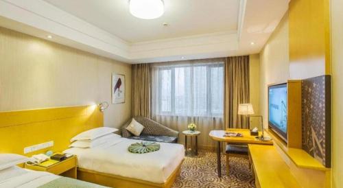 a hotel room with two beds and a flat screen tv at Huachen Kenzo Hotel Hangzhou in Hangzhou