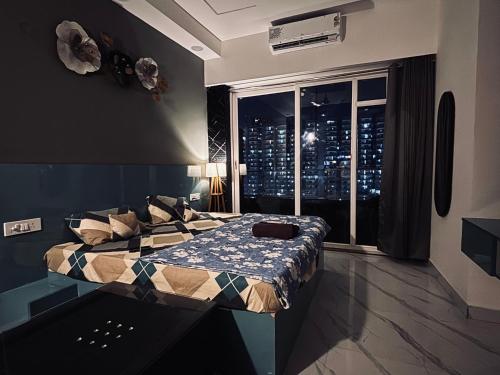 a bedroom with a bed with a view of the city at Zen studio in Ghaziabad