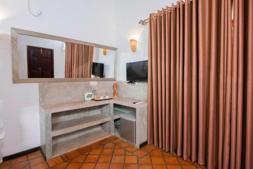 a bathroom with a sink and a mirror at Breeze Villa Unawatuna in Galle
