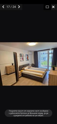 a bedroom with two beds and a large window at PremiumApartment in Burgas City