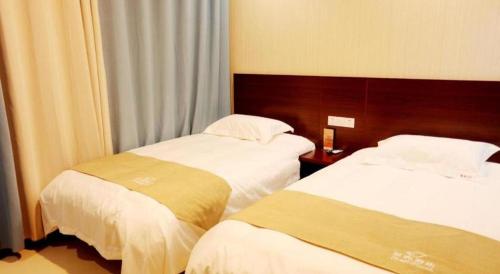 Katil atau katil-katil dalam bilik di Shell Zaozhuang Taierzhuang Ancient City East Gate Hotel