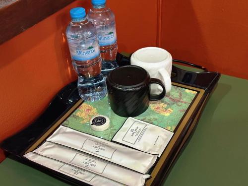 a tray with bottled water and two bottles of water at Little Friendly Guest House with pool in Luang Prabang