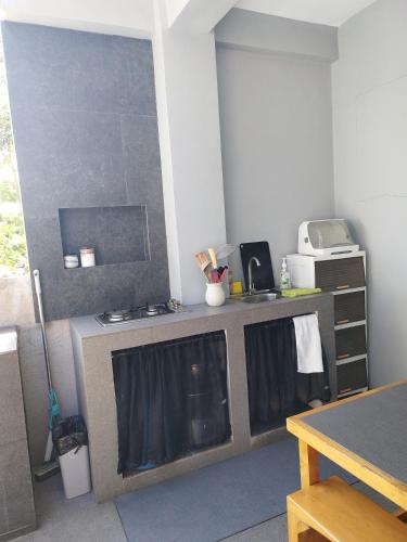 a kitchen with a sink and a counter top at Mamay's Place Barkada Room in Tagbilaran City
