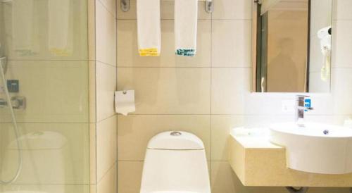 a bathroom with a toilet and a sink at City Comfort Inn Wuhan High Speed Railway Station in Wuhan
