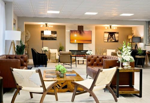 a lobby with a waiting room with couches and chairs at Ramada by Wyndham Sarasota Waterfront in Sarasota