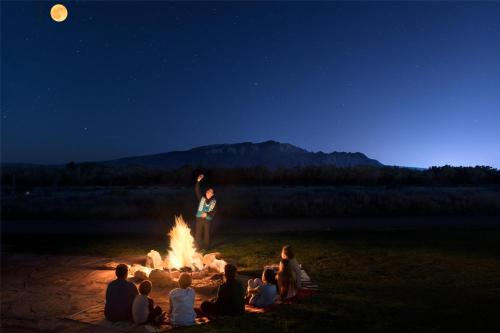 a group of people sitting around a camp fire at Hyatt Regency Tamaya South Santa Fe in Santa Ana Pueblo