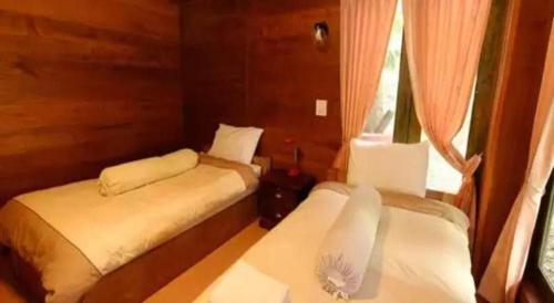 Postel nebo postele na pokoji v ubytování P&P Coffee & Resort Maesariang