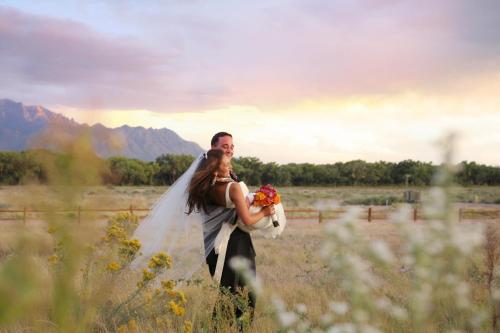 a bride and groom standing in a field at Hyatt Regency Tamaya South Santa Fe in Santa Ana Pueblo