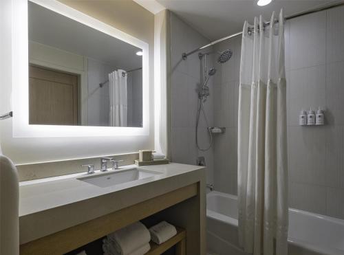 a bathroom with a sink and a shower and a mirror at Hyatt Regency Tamaya South Santa Fe in Santa Ana Pueblo