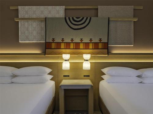two beds sitting next to each other in a room at Hyatt Regency Tamaya South Santa Fe in Santa Ana Pueblo