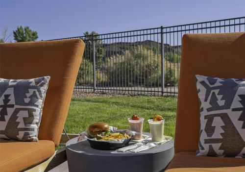 a tray of food on a table with two chairs at Hyatt Regency Tamaya South Santa Fe in Santa Ana Pueblo