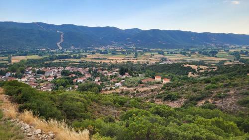a town on a hill with mountains in the background at Villa Domatia in Kavala