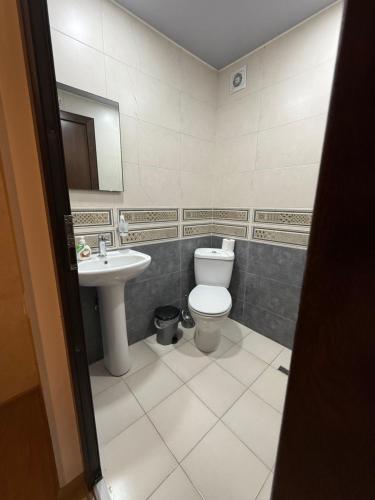 a bathroom with a toilet and a sink at nino hotel in K'obulet'i