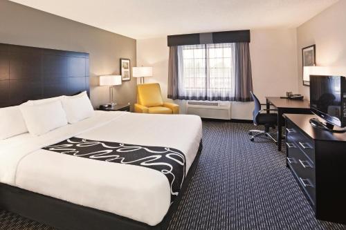 a hotel room with a large bed and a desk at La Quinta by Wyndham Denver Englewood Tech Ctr in Greenwood Village