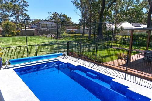 a swimming pool with a fence around it at Anglesey - Pet Friendly with Pool - 4 Mins Walk to Beach in Callala Bay