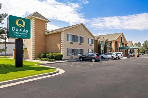 a sign in a parking lot in front of a building at Quality Inn & Suites Salt Lake City Airport West in Salt Lake City