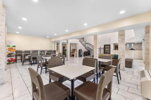 a dining room with tables and chairs in a restaurant at Quality Inn & Suites Salt Lake City Airport West in Salt Lake City