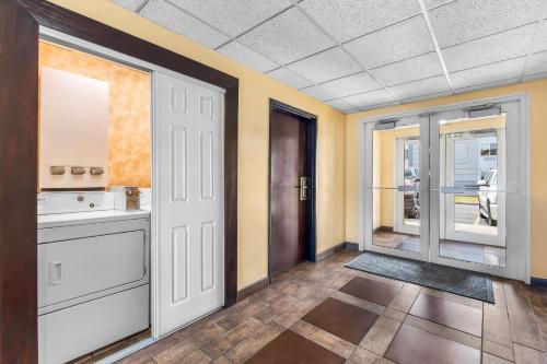 a room with a bathroom with a sink and a door at Quality Inn & Suites Salt Lake City Airport West in Salt Lake City