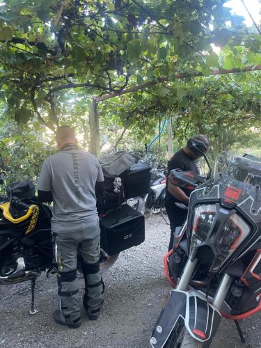 a man is standing next to a motorcycle at Domus Komanesse - Guest Houses in Koman