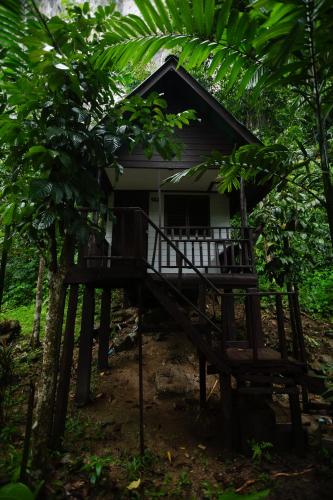 a small house in the woods with a porch at The Vatika Resort and Spa in Ao Nang Beach