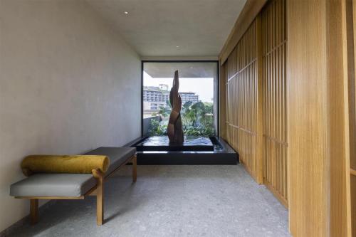 a room with a statue of a woman in an aquarium at Waldorf Astoria Costa Rica Punta Cacique in Playa Hermosa