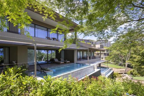 an external view of a house with a swimming pool at Waldorf Astoria Costa Rica Punta Cacique in Playa Hermosa